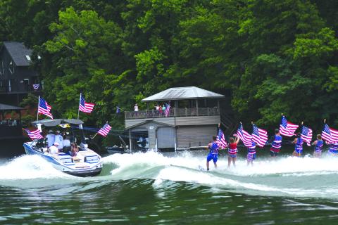Enoch Autry/The Clayton Tribune. The skiers are pulled by the boat across the waters on Lake Burton.