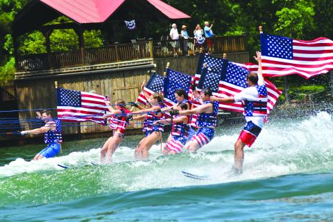 Enoch Autry/The Clayton Tribune. Ski Patriots wave to the crowds on July 3.