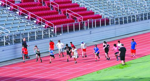 Enoch Autry/The Clayton Tribune. With coaches watching, student-athletes get in some early morning sprints at Rabun County High School. 