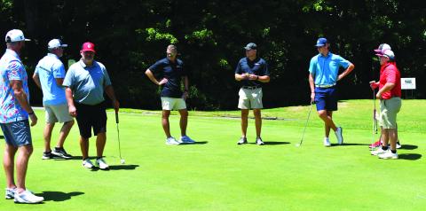 Enoch Autry/The Clayton Tribune. Players spend some time on the practice putting greens at Kingwood Resort Golf Course prior to the start of the inaugural Rabun County Booster Club Wildcat Open Golf Tournament on July 22. The event raised more than $9,000 to go toward the sports teams at the middle school and high school.