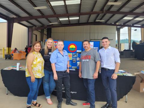 Megan Broome/The Clayton Tribune. Paula Macedo, Migrant Program Liaison for Gainesville City Schools, Vanesa Sarazua with Hispanic Alliance, Evelyn Arevalo, Region 1 Migrant Education Program Recruiter for the Georgia Department of Education, Roberto Aguilar, Migrant SSP for Rabun County Schools, and Rodney Santana, volunteer from Hall County, participate in the Hispanic Information and Health Fair on July 22 at the Osage Farms packing house in Rabun Gap. 