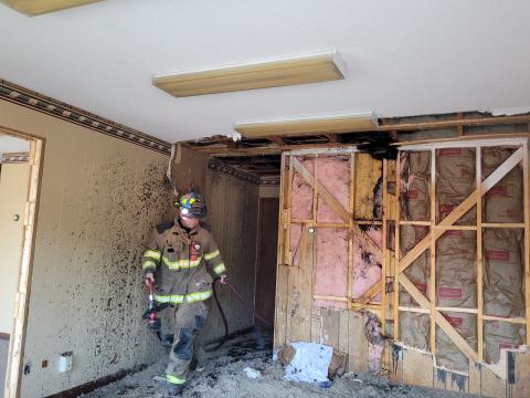 Megan Broome/The Clayton Tribune. Firefighters search the Ed West Realty building on Savannah Street after being dispatched to a rekindling following a call for a possible structure fire at the same location almost 12 hours earlier, where a small fire possibly caused by lightning was found in the attic. 