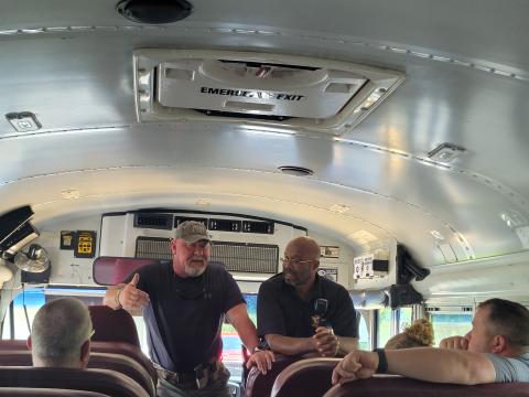Megan Broome/The Clayton Tribune. Lt. Mark Gerrells and Sgt. Lindsey Owens, School Resource Deputy at the high school, talk to bus drivers at the Board of Education Tuesday as part of their annual safety training to prepare for kids as they go back to the classroom Friday. They talked to bus drivers about the importance of situational awareness and being aware of surroundings. He referred to the buses as “mobile classrooms” and talked about what to do in the instance of an active shooter situation. 