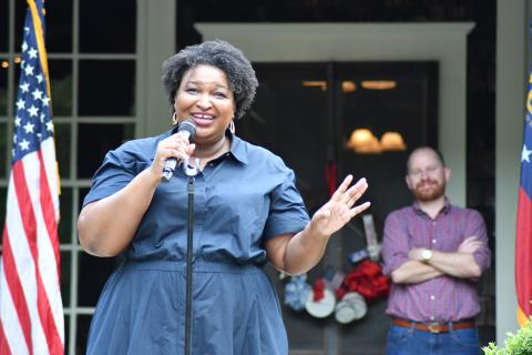 Enoch Autry/The Clayton Tribune. Democratic nominee Stacey Abrams addresses the crowd at the Parker Ranch on July 29. Standing behind Abrams is Charlie Bailey, who seeks the elected position of lieutenant governor.