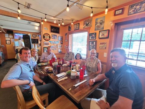 Megan Broome/The Clayton Tribune. Gov. Brian Kemp and Georgia First Lady Marty Kemp have a chicken sandwich with fries for lunch with local officials at The Rusty Bike Café Aug. 4 when the governor made a visit to Rabun County to meet-and-greet members of the community. Pictured are Hunter Spear, Northeast Georgia field director for Kemp for Governor, left; Georgia First Lady Marty Kemp; Georgia Gov. Brian Kemp; Sheriff Chad Nichols; Joslan Nichols; Cathy Cannon; and Clayton Mayor Kurt Cannon. 