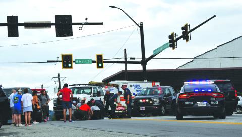Enoch Autry/The Clayton Tribune. Rabun County emergency personnel assist a pedestrian who was struck by a vehicle in downtown Clayton.