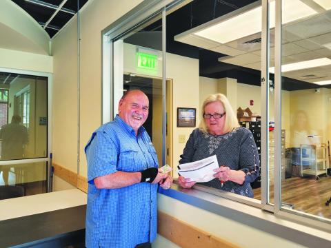 Megan Broome/The Clayton Tribune. Chuck Coulson, left, updates his voter registration information with Sandra Wood, elections and registrations clerk, at the Rabun County Board of Elections and Registrar’s Office recently. 