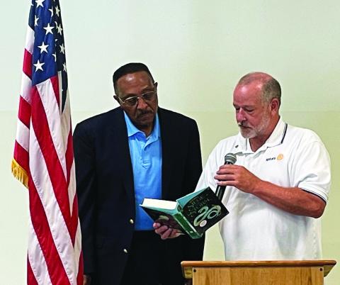Photo courtesy of Jim Antosiak. Rotary Club of Clayton President Leif Ericson, right, presents a book to NASA Astronaut Winston Scott at the Rotary Club of Clayton meeting after Scott spoke Aug. 18. The book was autographed and donated to a local school library in Rabun County. 