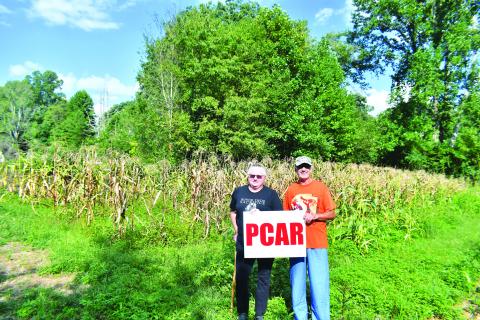 Megan Broome/The Clayton Tribune. Megan Broome/The Clayton Tribune. Pam Wheeler, CFO of Creating Ties That Bind: For Soldiers and Families Wounded By Loss (left) and Dr. Guy Gober hold a sign representing the Nonprofit Prostate Cancer Awareness Resources, Inc. (PCAR). Both nonprofits are hosting the Inaugural Tiger Corn Festival Sept. 24 and members of the public will be able to purchase ears of organic corn from this field during the festival.
