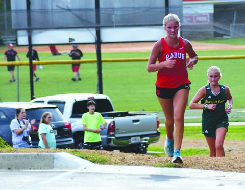Enoch Autry/The Clayton Tribune. RCHS’s Molly Jo Wright and Rabun Gap’s Bailey Brackett head toward the stadium at the unveiling of the new course Aug. 18. Wright claimed second and Brackett took third.