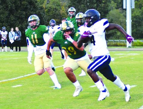 Enoch Autry/The Clayton Tribune. University Christian senior running back Orel Gray cuts sprints by Rabun Gap-Nacoochee’s Joaquin Acuna (29) and Noah Classen (11) in the Christians’ 49-13 win as the school from Florida came to North Georgia Sept. 23. Gray had 284 rushing and receiving combined yards.