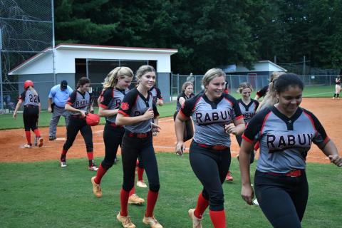 The Lady Cats celebrate a two-run home run from senior Mary Lovell (left) against Habersham Central.