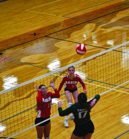 Luke Morey/The Clayton Tribune. RGNS sophomore Cathryn Carmack goes up for a kill against RCHS juniors Anna Raye Darnell and Mira Tinnefeld. The Lady Cats went 1-1 while the Eagles went 2-0. 