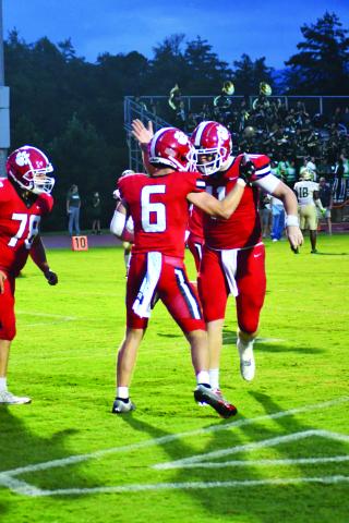 Enoch Autry/The Clayton Tribune. Senior Jaden Gibson (left) celebrates his fourth touchdown of the night with senior quarterback Keegan Stover (right) who ended with a record-setting eight passing touchdowns.