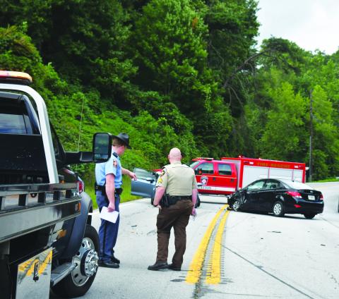 Megan Broome/The Clayton Tribune. Georgia State Patrol Trooper Brady Galloway and Rabun County Sheriff’s Office Sgt. Cody Sanders analyze the scene of a four-vehicle crash on Georgia 15 at File Street near George Eller Curve in Mountain City September 5.