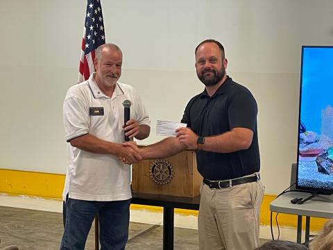 Photo courtesy of Jim Antosiak. Rotary Club of Clayton President Leif Ericson hands a $2,429 donation check to Dr. Matthew Leff at the Rotary Club of Clayton meeting Aug. 18. 