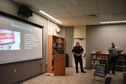 Megan Broome/The Clayton Tribune. Clayton Police Department Chief of Police Andy Strait and Investigator Matt Thomas educate the public on how to prevent becoming victim to different types of scams at the Rabun County Public Library earlier this month. 