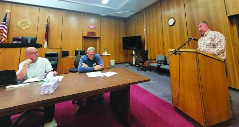 Megan Broome/The Clayton Tribune. County Attorney Allyn Stockton speaks to commissioners about amendments to the zoning ordinance for short-term rentals at the Board of Commissioners meeting Sept. 27. Commissioners Scott Crane and Tom Garrison are also pictured. Commissioners adopted the first reading of the ordinance amendment. 