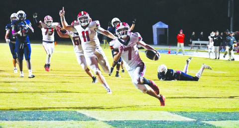 Luke Morey/The Clayton Tribune. With an excited senior quarterback Keegan Stover behind him, Rabun County senior running back Lang Windham (7) runs into the end zone for his second touchdown of the night, which ended up being the game-winning score against St. Francis. Windham finished with 19 carries on 108 yards, good for more than five yards per rush. RCHS will be on the road at region foe Elbert County Friday.