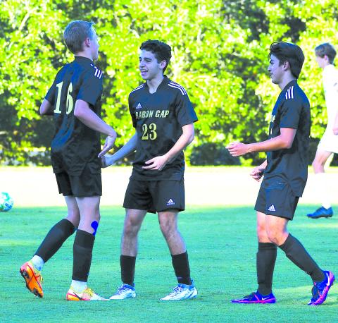 Luke Morey/The Clayton Tribune. Moteijus Samsonas (left) celebrates his goal with Marcello Gonzalez (middle) and Rafael Castillo (right) at the Eagles’ last home game on Sept. 13 against Asheville Christian Academy where the Eagles won 6-1. Samsonas is tied for second on the team in assists. 