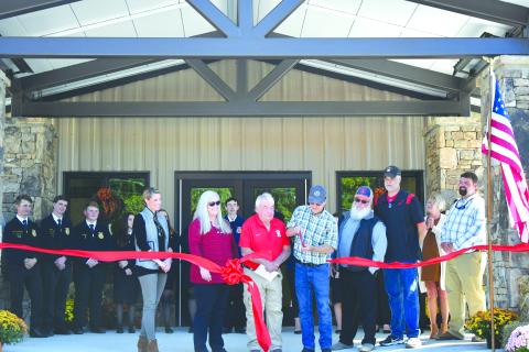 Enoch Autry/The Clayton Tribune. Rabun County Board of Education Chair and retired RCHS agriculture teacher Steve Cabe cuts the ribbon on the Rabun County Schools Agri-Science Center October 6. Pictured are Cabe with Rabun County FFA students; Board of Education Member Molly Lima; Rabun County Schools Superintendent Dr. April Childers; Rabun County Board of Education Members Wayne Stephens; Mark Beck; and Rabun County Board of Education Vice-Chair Curt Haban with Agriculture Education Instructor Clay Brown.
