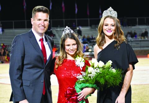 Luke Morey/The Clayton Tribune. The RCHS 2022 Homecoming Queen Rainny Patterson (center) poses with Principal Justin Spillers and 2021 Homecoming Queen Janice Steill at halftime. 