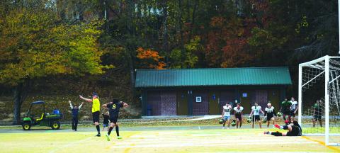 Luke Morey/The Clayton Tribune. Joined by the football team, senior Emilio Roman celebrates his penalty kick that sent the Eagles to the state championship game. The Eagles will face off against Carmel Christian in a rematch of last year’s title game. 