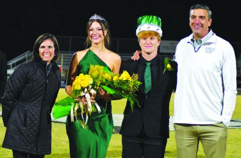 Enoch Autry/The Clayton Tribune. Homecoming Queen Cheney Moriarty and King Zeke Coghill pose with Head of School Jeff Miles and wife Kiana Miles.