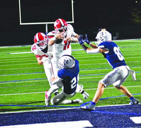 Luke Morey/The Clayton Tribune. RCHS senior quarterback Keegan Stover powers his way into the end zone as he is helped by a push from senior center Skip Speed (72).