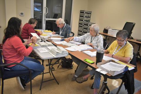 Megan Broome/The Clayton Tribune. Poll workers are gearing up for early voting and the Nov. 8 election. Shay Harbin, office assistant; and absentee poll workers Elaine Lawson; Rick Crouse; Mary Ann Rich; and Virginia Anderson work to mail out absentee ballots to voters on Tuesday. 