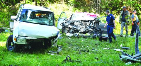 Megan Broome/The Clayton Tribune. Emergency personnel work at the scene of a Sept. 28 two-vehicle crash on Georgia 2 east of McWorter Lane in Rabun County just before the Georgia-South Carolina state line. Two female passengers from Franklin, N.C., suffered fatal injuries as a result of the crash and a Clayton man was life-flighted from the scene with reported serious injuries. 