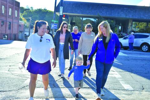 Megan Broome/The Clayton Tribune. Laura Davis, Finnley Smith, Jekka Smith, Jenifer Kulow, Susan Kulow and Dena Crane participate in the Hope Walk in solidarity with those who have been affected by domestic violence to bring awareness to October as “Domestic Violence Awareness Month.”