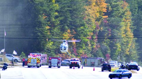 Enoch Autry/The Clayton Tribune. A helicopter lands on Georgia 15 at Seed Tick Road in Clayton Oct. 21 and emergency personnel work the scene following a crash involving a vehicle and motorcycle.