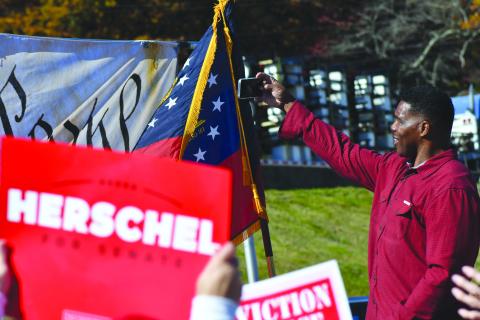 Enoch Autry/The Clayton Tribune. Republican candidate for U.S. Senate Herschel Walker takes a selfie at a campaign stop in Rabun County on Oct. 26 at the Piggly Wiggly in Dillard. Walker is projected to face incumbent Rev. Raphael Warnock in a Dec. 6 runoff after neither candidate got the needed votes to win Tuesday’s race. This is one of the hottest races in the United States. 