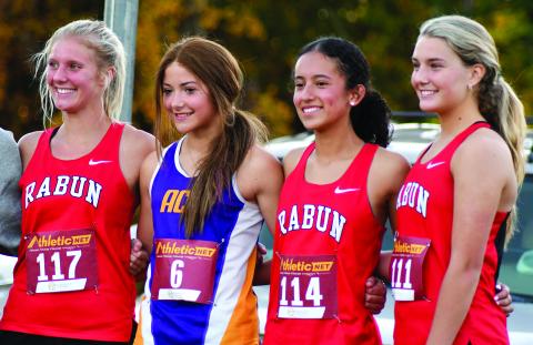 Enoch Autry/The Clayton Tribune. Rabun County Lady Cats cross country runners Molly Jo Wright, Itzia Vasquez and Trea Blalock stand on the individuals’ podium with Athens Christian’s Josi Vaughn for finishing in the top 10 at the region meet.
