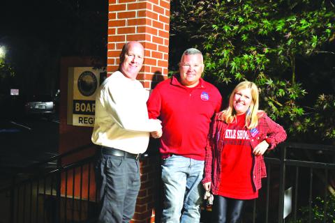 Megan Broome/The Clayton Tribune. Candidates for Magistrate Judge James Blalock and Kyle Shook shake hands outside the Rabun County Board of Elections Office Tuesday evening as they await election results. Also pictured is Sonya Shook. 