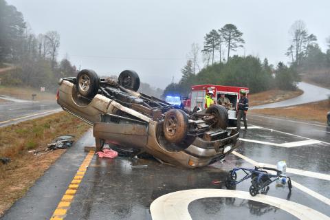 Megan Broome/The Clayton Tribune. First responders work the scene of a single vehicle crash for a vehicle that overturned on Ga. 15 at Razorback Lane in Lakemont Nov. 11. The driver, a Clarkesville, Ga. man, sustained possible minor injuries as a result of the crash. 