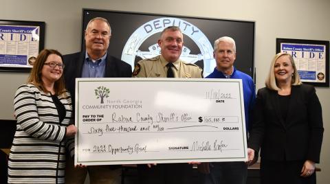 Megan Broome/The Clayton Tribune. Rabun County Commissioner Kent Woerner, Sheriff Chad Nichols and Rep. Stan Gunter are presented with the 2022 Opportunity Grant from the North Georgia Community Foundation by Abigail Carter, director of strategic initiatives for the North Georgia Community Foundation, and Michelle Prater, president and CEO of the North Georgia Community Foundation. The $65,000 check was presented at the Rabun County Sheriff’s Office Nov. 18. 