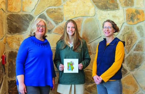 E. Lane Gresham/Tallulah Falls Schools. Tallulah Falls School senior Kaylin Neal of Flowery Branch produced the winning artwork in a student art contest for the 2022 Twin Rivers Challenge T-shirt. Shown, from left are Smith, Neal and art teacher Stephanie Stuefer. 