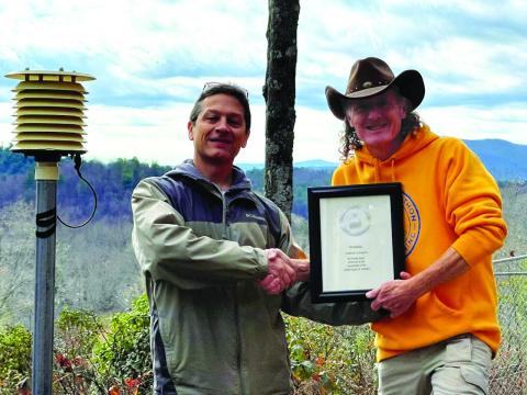 Submitted photo. Anthony Lampros, right, receives a certificate from National Weather Service Meteorologist Chris Horne in recognition of over 20 years of service for weather observation in the area.