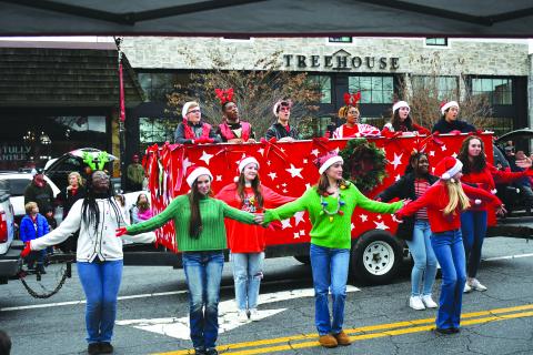 Enoch Autry/The Clayton Tribune. Rabun Gap-Nacoochee School students sing and dance to Christmas music at the annual Clayton downtown parade on on Main Street on Dec. 3. Singing from the float (from left) are Tyler Price, Chidera Onyia, Cyrus Manoogian, Sharra Rolle, Vivi Diaz and Vivian Guo. The dancers (from left) are Blaire Lauder-Williams, Elizabeth Brenner, McKenna Bilbrey, Anni Geren, KayKay Justilien, Abigail Brenner and and Emma Jenkins. 