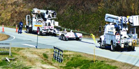 Enoch Autry/The Clayton Tribune. Crews bring in a new power pole on Worley Creek Road to replace a pole damaged by the gusting winds on Dec. 23 as the temperatures in the county dipped below zero.