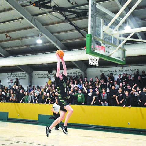Luke Morey/The Clayton Tribune. Senior Theo Antinori ends the fast break with a dunk as the student section goes wild on Friday night. Antinori had 29 points on Friday before going off for 30 on Saturday.