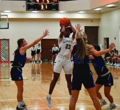 Luke Morey/The Clayton Tribune. Senior Denika Lightbourne goes up for a shot against two Lake Oconee defenders on Wendesday, Dec. 7. The Lady Indians are on a six-game losing streak.