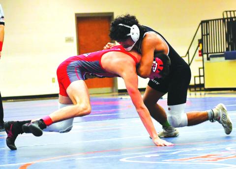 Luke Morey/The Clayton Tribune. Rodolfo Ramos gets a chokehold on Tucker Kinsey from Stephens County in the placement match during the Raider Invitiational on Saturday, Dec. 10. Ramos won his weight class after defeating Kinsey.