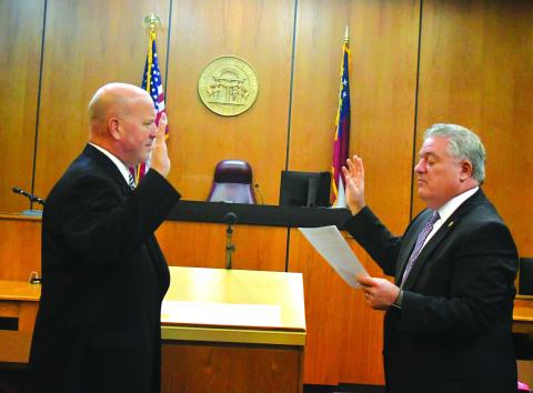Megan Broome/The Clayton Tribune. James V. Blalock takes the oath of office as Rabun County magistrate judge as he is sworn-in by Judge Russell W. Smith.
