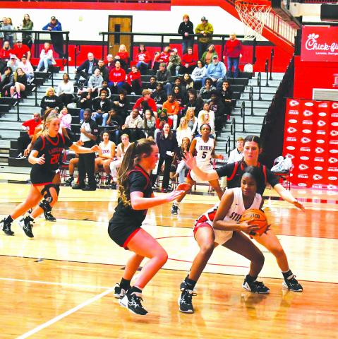 Luke Morey/The Clayton Tribune. With Rabun County High School Lady Cat junior Ellie Southards in the background, junior Mili Watts (middle) and senior Mary Lovell trap Stephens County’s Jaziya Harbin in the first quarter of a 56-26 victory. The Lady Cats now are 14-1 with region games up next.