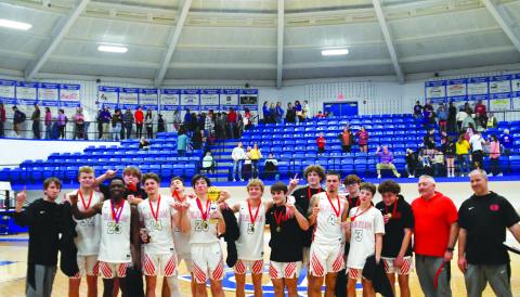 Enoch Autry/The Clayton Tribune.  Senior Jayton Henry holds the trophy after he and his Rabun County Wildcat teammates defeat Union County 54-53 on Dec. 30 for the Battle of the States championship. 