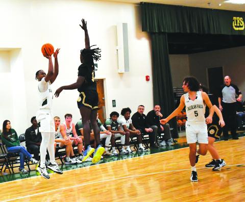 Luke Morey/The Clayton Tribune. TFS senior Anfernee Hanna hits a three against Commerce on Friday, Jan. 13. Hanna had 17 points as TFS split their games over the weekend, falling to Prince Avenue Christian on Saturday. 