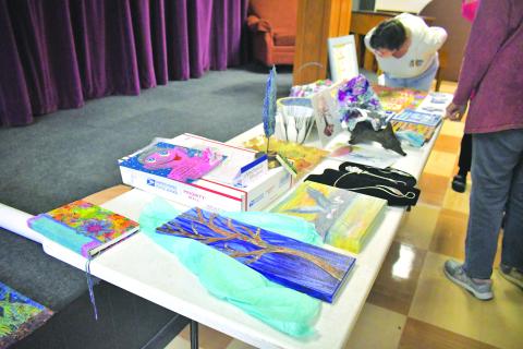 Megan Broome/The Clayton Tribune. Over 20 members of the North Georgia Arts Guild displayed their works at the annual Members Show and Tell themed “Winter Blues” during the organization’s meeting Feb, 16. Artists gave presentations for each of their works, describing the medium and inspiration behind them, then displayed them for other Guild members to observe and converse about during the meeting. 